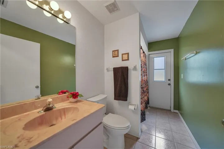 Guest bathroom with exit to lanai.