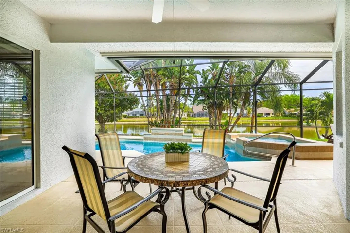 Integrated pool / hot tub featuring a sunroom, a patio, and a lanai