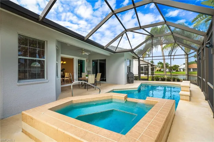 Integrated pool / spa featuring a sunroom, a grill, a patio, and a lanai