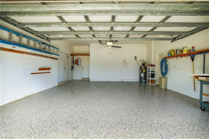 Swimming pool featuring a patio, an in-ground hot tub, a sunroom, a lanai, and a water view