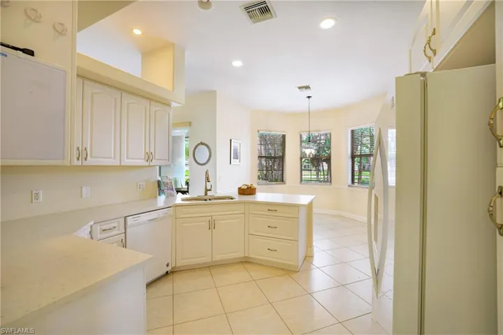 Unfurnished dining area with light tile patterned floors and hanging lights