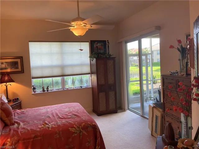 Bedroom featuring carpet flooring, ceiling fan, and access to exterior