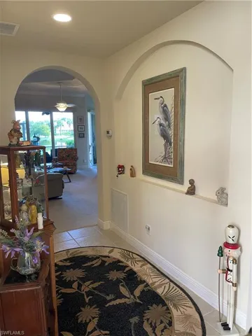 Corridor with light tile patterned floors