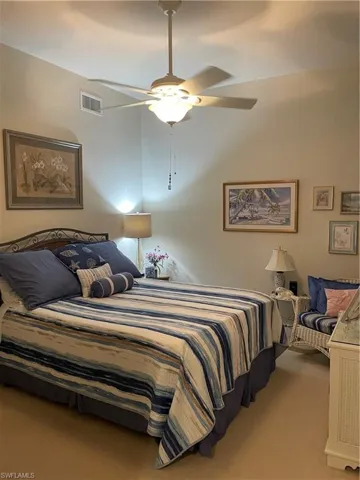 Carpeted bedroom featuring ceiling fan