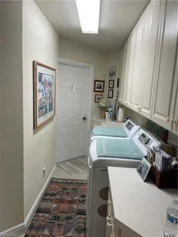Laundry room featuring cabinets and independent washer and dryer