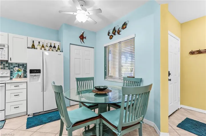 Dining area featuring light tile patterned flooring and ceiling fan