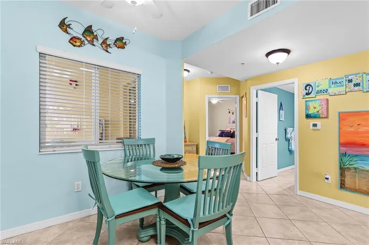 Dining space featuring ceiling fan and light tile patterned floors