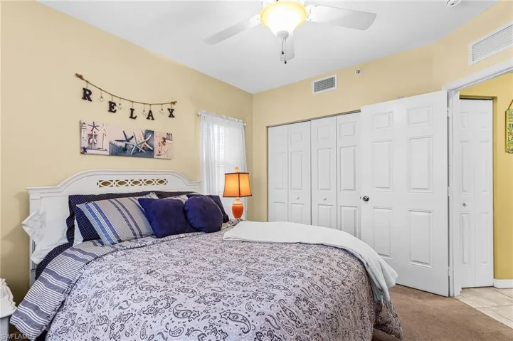 Bedroom with carpet, a closet, and ceiling fan