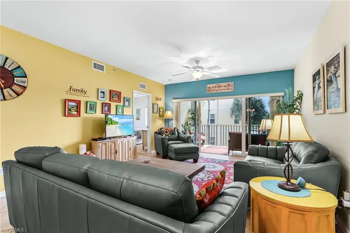 Living area featuring a ceiling fan and baseboards