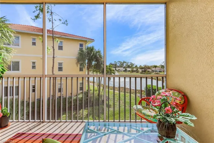 Sunroom / solarium featuring a water view and a residential view