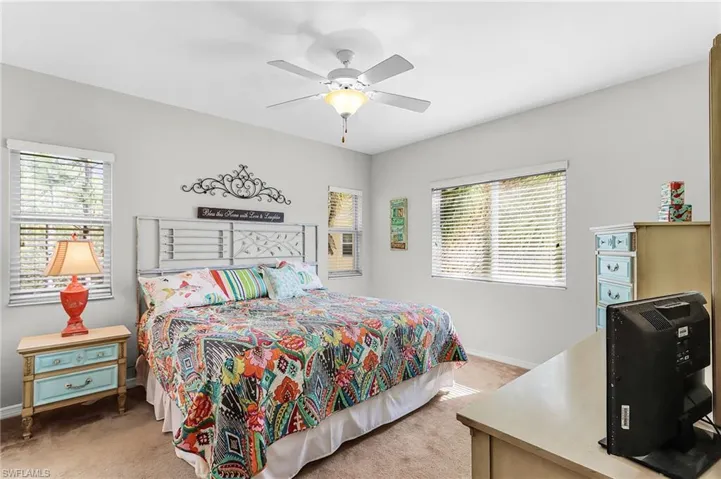 Bedroom with light carpet and ceiling fan