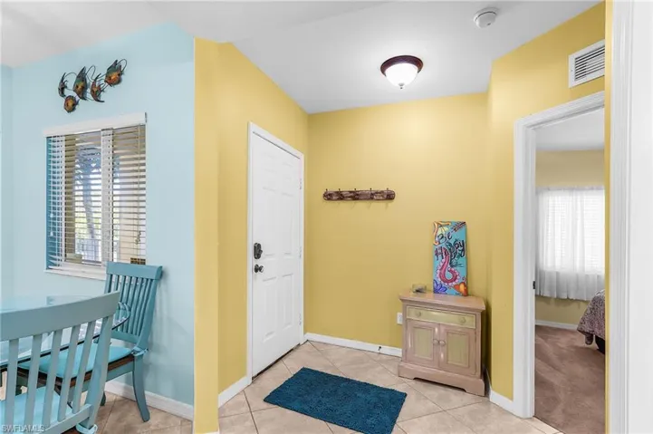 Foyer entrance featuring light tile patterned floors
