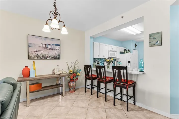 Dining space featuring a chandelier and light tile patterned flooring