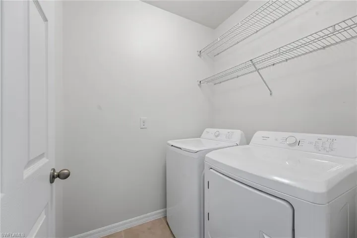 Laundry with additional shelving.