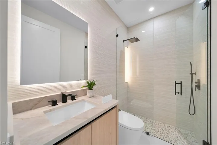 Bathroom with a stall shower and vanity