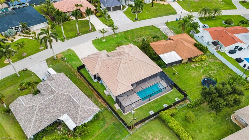 Aerial perspective of suburban area with a pool