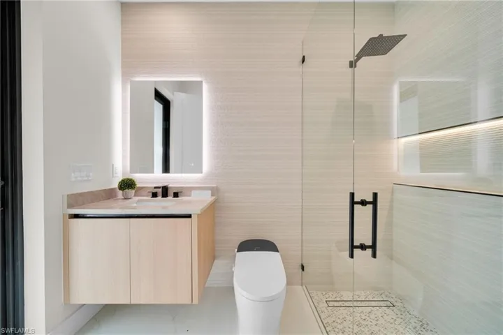 Bathroom featuring a stall shower and vanity