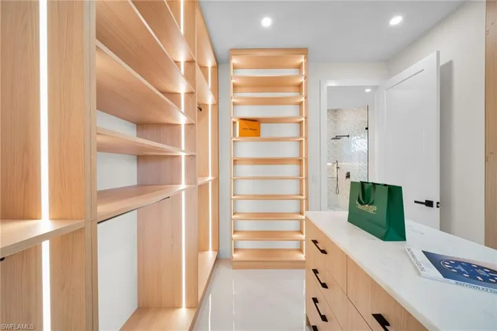 Spacious closet with light marble finish flooring