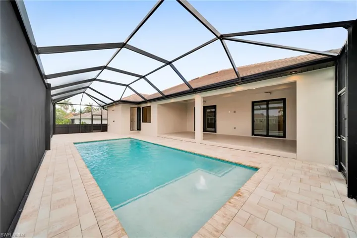 Swimming pool with a patio area and a lanai