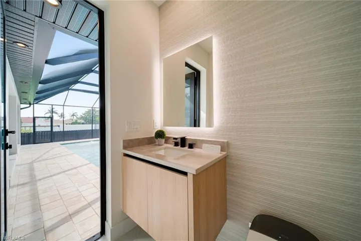 Half bathroom featuring vanity and toilet