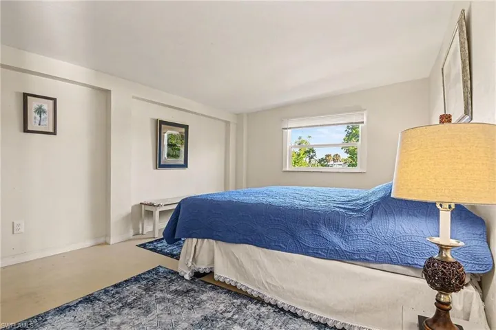 Bedroom with finished concrete floors and baseboards