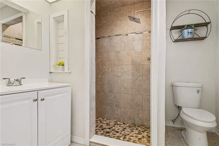 Bathroom featuring a shower stall, vanity, and tile patterned floors