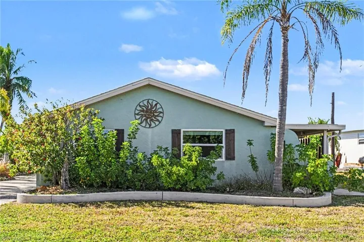 View of side of home featuring stucco siding and a yard