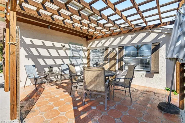 View of patio featuring a pergola and outdoor dining space