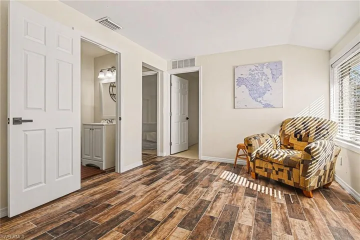 Living area with wood tiled floors and lofted ceiling