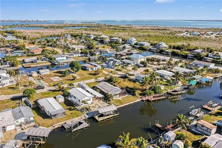 Aerial overview of property's location with nearby suburban area and a nearby body of water