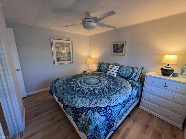 Bedroom #3 KING Bed with ceiling fan and light hardwood / wood-style flooring