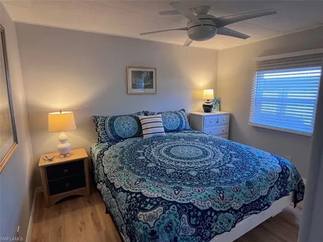 Bedroom with light hardwood / wood-style flooring and ceiling fan