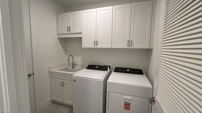 Laundry room with additional soft-close cabinetry and laundry tub