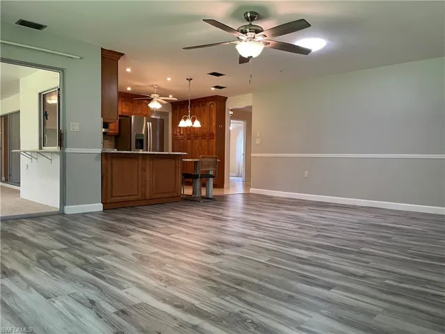 Unfurnished living room with recessed lighting, dark wood-style floors, and a ceiling fan