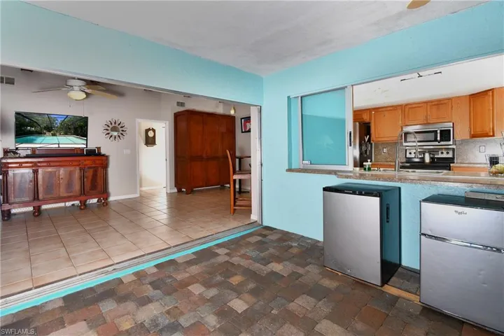 Three pocket sliding doors to the family room and pass through bar to the kitchen