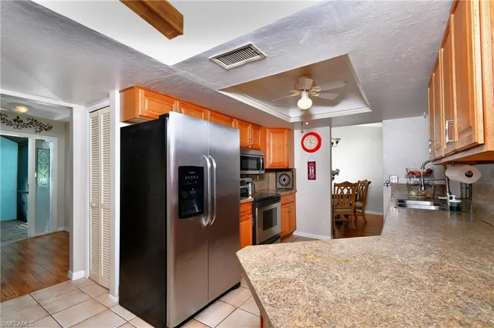 Pantry, wood cabinets, stainless steel appliances.