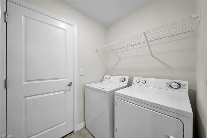 Functional laundry area featuring a full-size washer and dryer