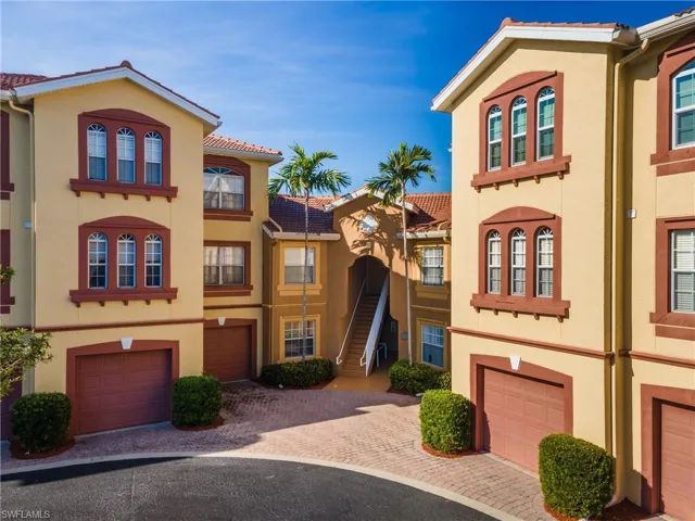 Mediterranean / spanish-style house with stucco siding, a garage, driveway, and a tiled roof