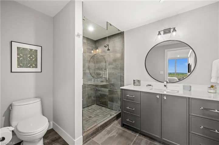Full bath with vanity and a shower stall