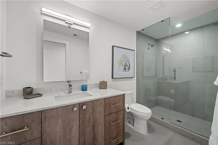 Bathroom with vanity and a shower stall