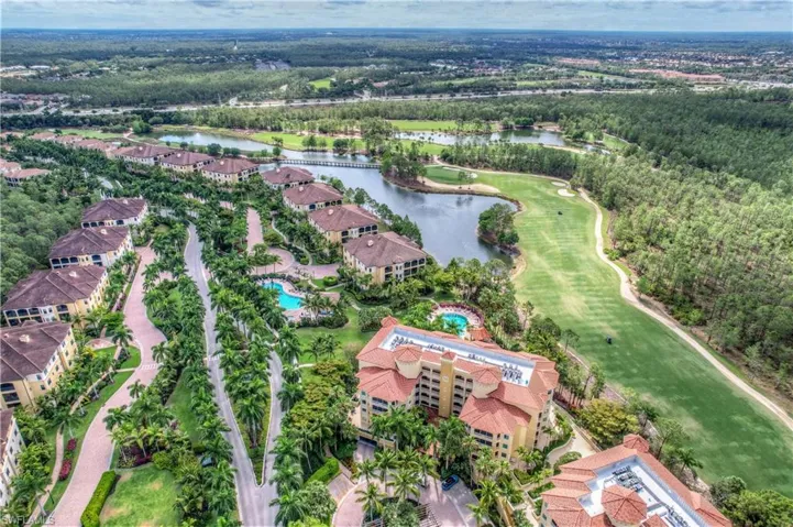 Birds eye view of property with a water view