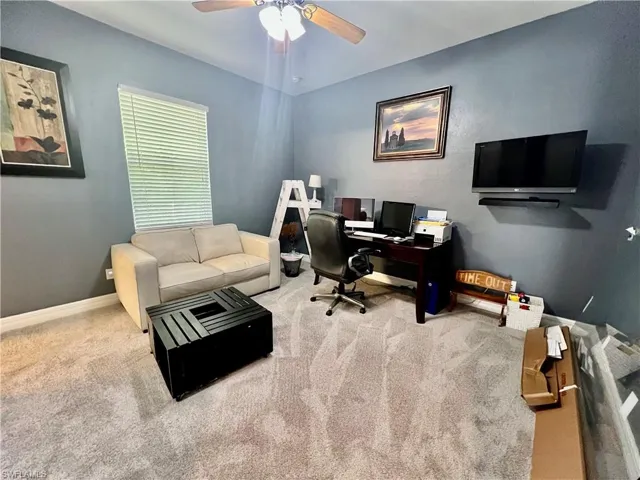 Guest bedroom featuring ceiling fan and baseboards