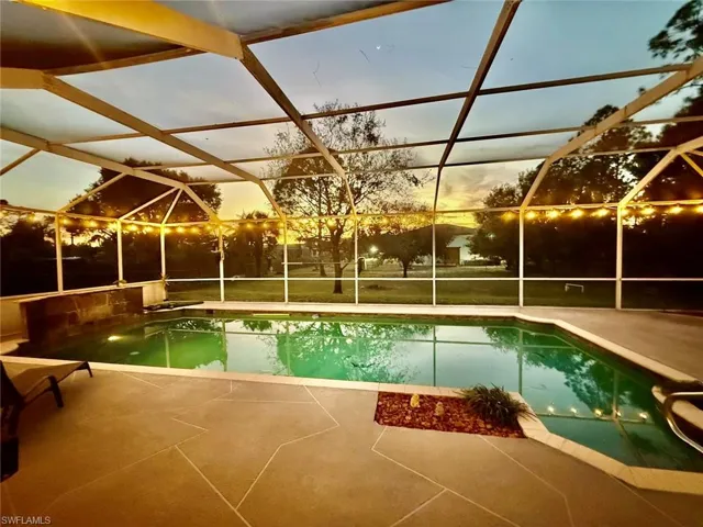 Pool featuring a large  patio with night lighting excellent for entertaining.