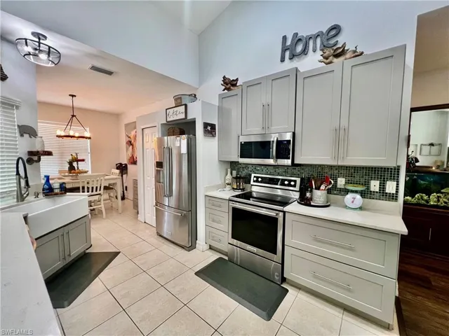 Kitchen with QUARTZ tops, breakfast bar and stainless steel appliances.