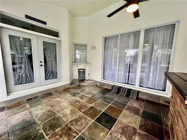Covered patio with pass through from the kitchen and French doors.