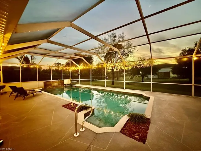 Pool featuring a large  patio with night lighting excellent for entertaining.