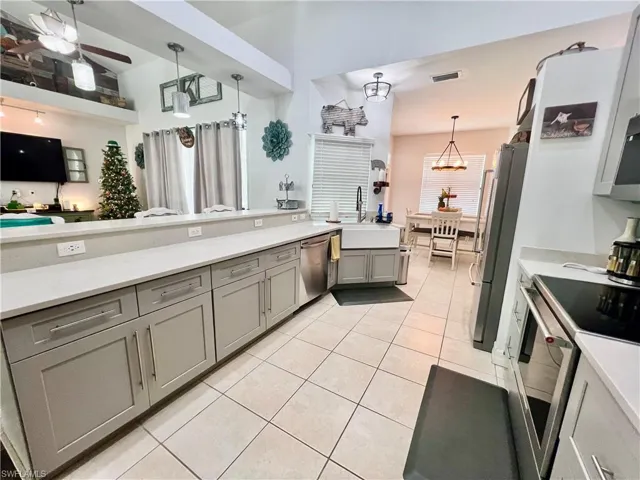 Kitchen with QUARTZ tops, breakfast bar and stainless steel appliances.