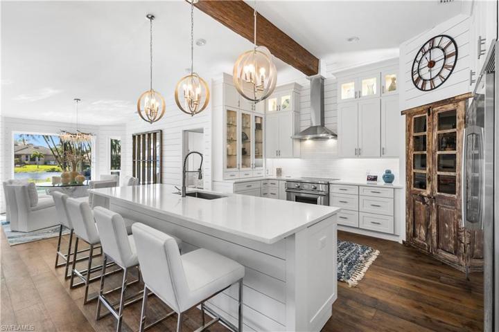 This stae of the art kitchen is a chef's dream! Electrolux refrigerator, Wolf stove, Large quartz island, quartz backsplash and a custom built pantry! Soft close drawers, custom pull outs, shiplap. The unique cabinetry has glass doors and lighting. The lighting above is sure to please!