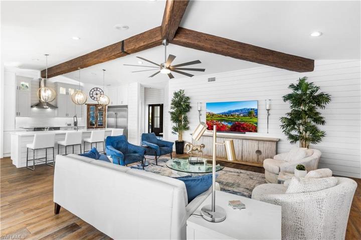 The family room offers exposed faux wood beams, shiplap walls. Great for entertaining intimate or large groups!