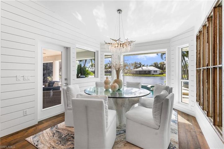 Formal dining has shiplap and delicious views of the pool and lake! You have access to your lanai from here as well.